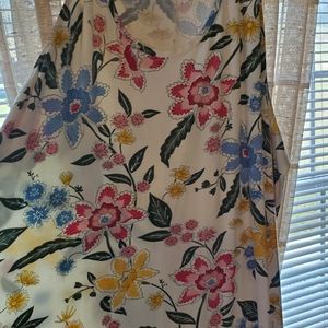 Never worn. Beautiful and vibrant flower sleeveless tee.